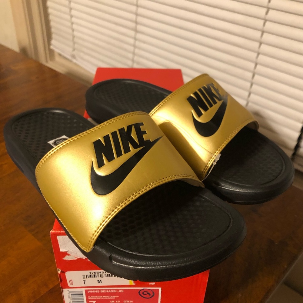 Women’s benassi gold Nike slides